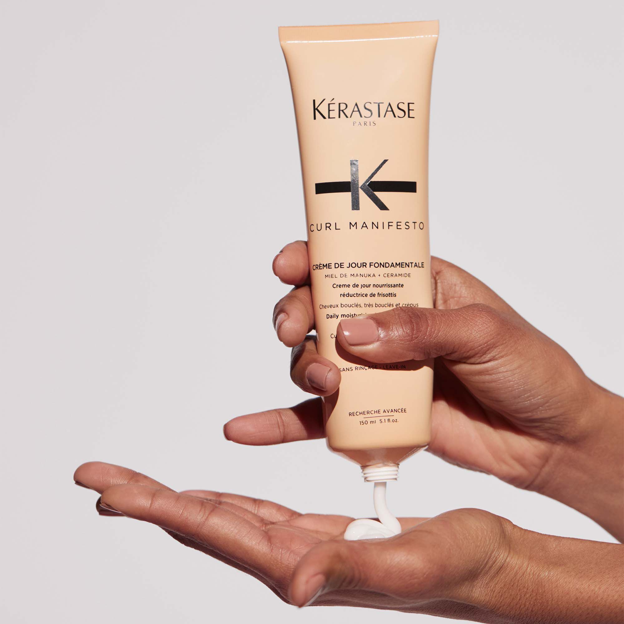 Kerastase Curl Manifesto Creme de Jour Fondamentale Hair Cream in hand