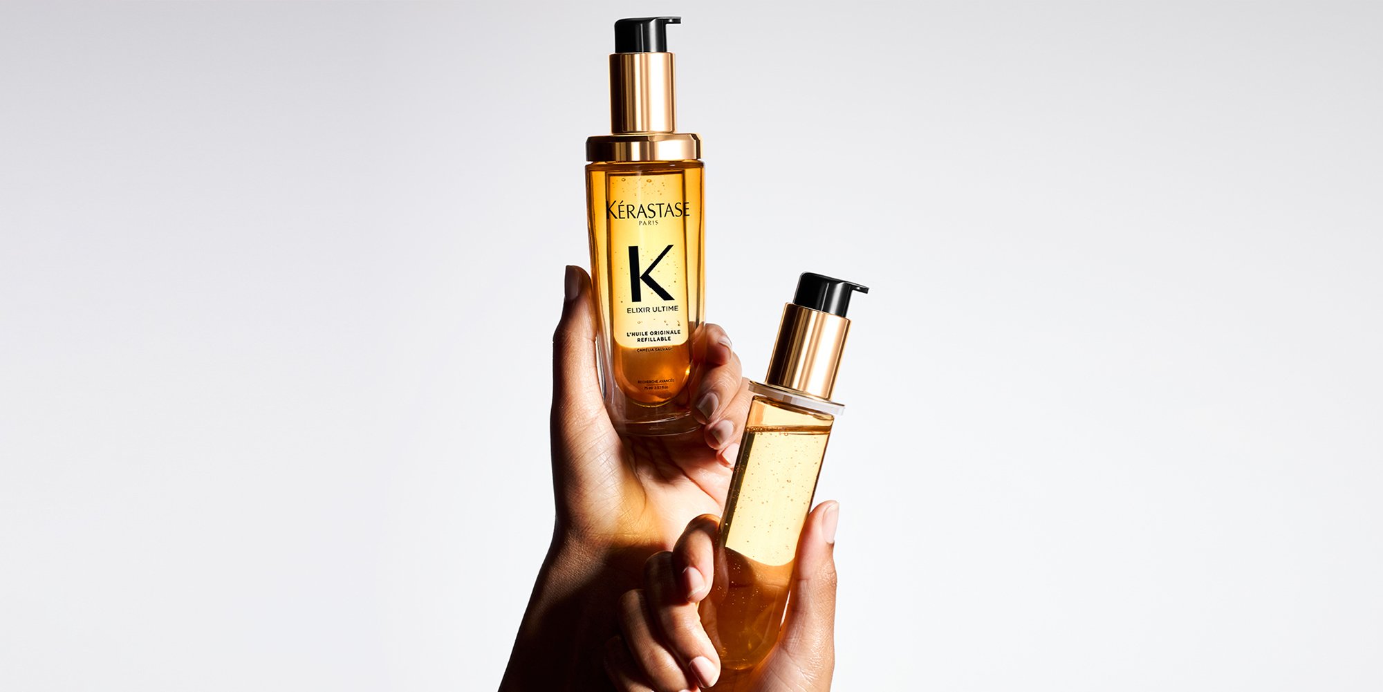 The Elixir Ultime hair mask and the new refillable Elixir Ultime hair oil are display on a pure beige background.